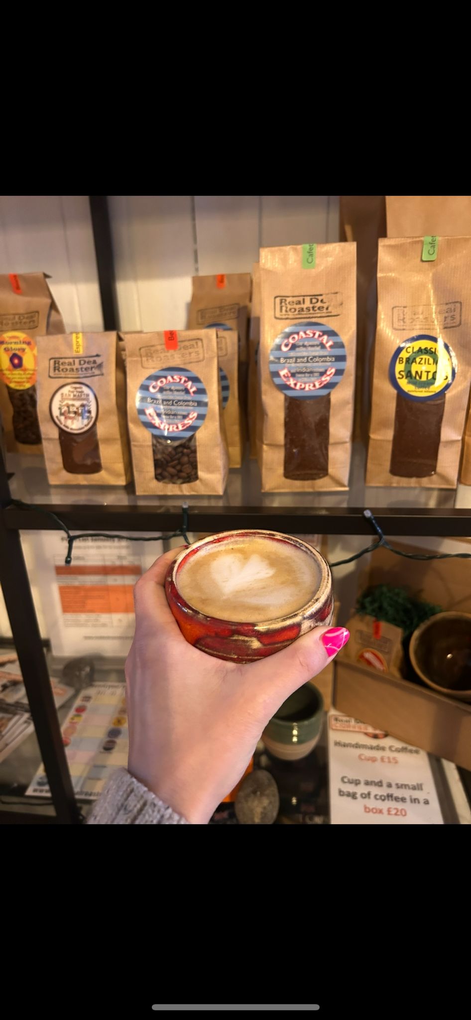 Cup of coffee in front of bags of coffee