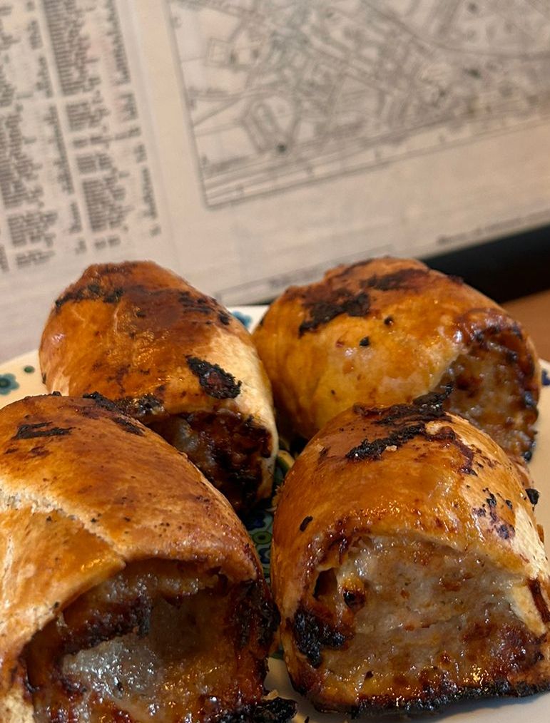 Sausage Rolls on a plate in front of a map